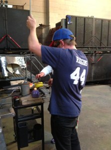 very hot glass melting onto float to make weighted bottom...