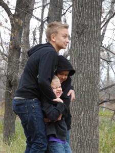 boys standing on a stump...
