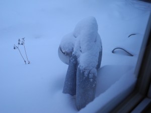 statue and snow covered chair...