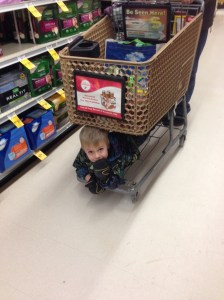 riding under the grocery cart...